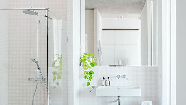 A bathroom with a tub, sink, and shower
